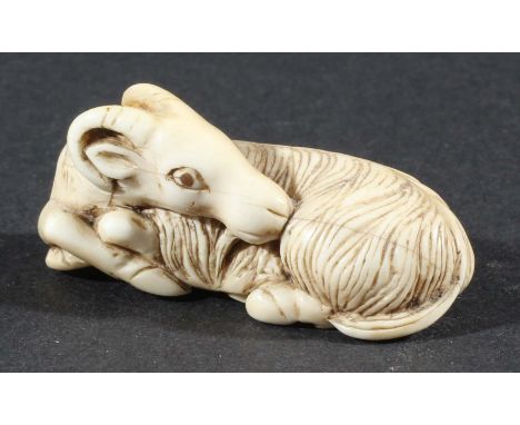 JAPANESE NETSUKE, probably ivory, of a recumbent goat, length 4.5cm