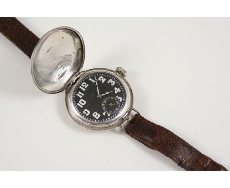 A SILVER WRISTWATCH the silver full hunting cased watch with black enamel dial with white Arabic numerals and subsidiary seco