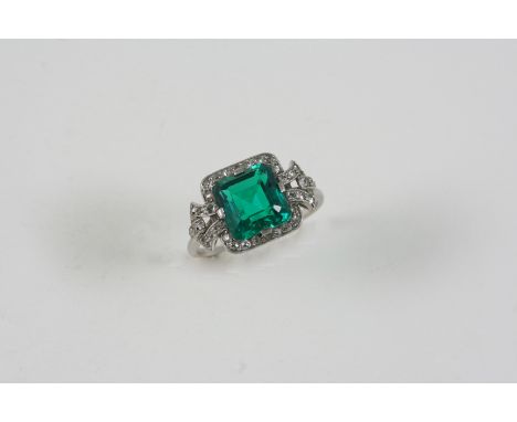 AN EMERALD AND DIAMOND RING the octagonal-shaped emerald is set within a surround of single-cut and circular-cut diamonds. Si