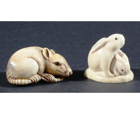 TWO JAPANESE NETSUKE, the first in ivory of two rabbits, the second in bone of a rat (2)