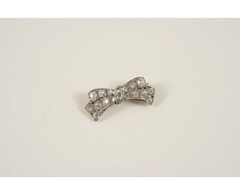 AN EARLY 20TH CENTURY DIAMOND BOW BROOCH the stylised bow is millegrain set with graduated old cushion-shaped brilliant-cut d
