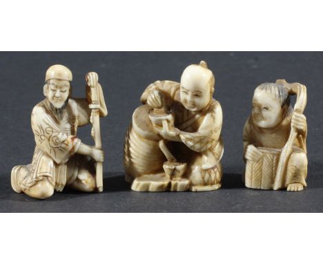 THREE JAPANESE NETSUKE, modelled as men at various activities, one with carved signature (3)
