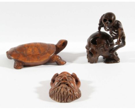 JAPANESE HARDWOOD NETSUKE, carved as a skeleton and a skull, height 5cm; together with a boxwood netsuke of a tortoise and an