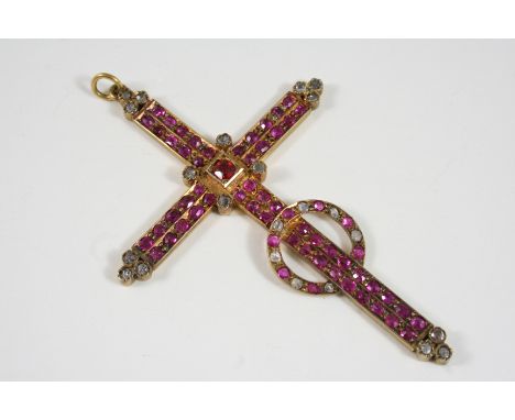 A RUBY AND DIAMOND CRUCIFORM PENDANT set overall with circular-cut rubies and rose-cut diamonds, in gilt metal, 8.5 x 6cm. In