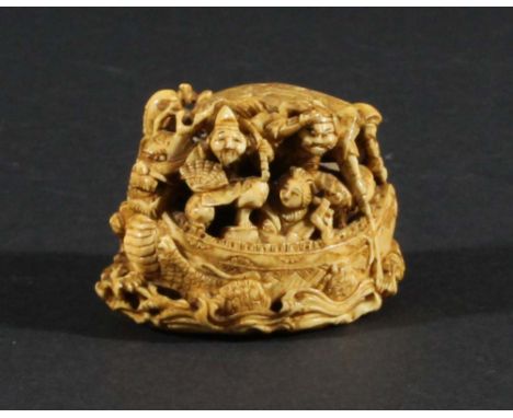 JAPANESE IVORY NETSUKE, carved as a melee of figures in a boat, the underside carved with scrolling waves and a signature, le