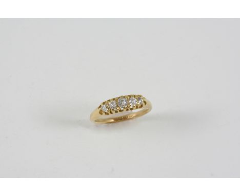 A DIAMOND FIVE STONE RING set with five graduated diamonds, in 18ct. gold. Size K 1/2.