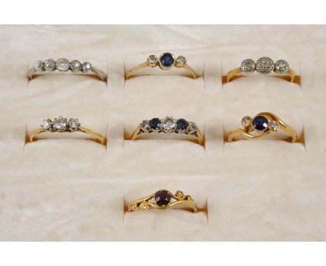 A SAPPHIRE AND DIAMOND FIVE STONE RING set with three circular-cut diamonds and two circular-cut sapphires in 18ct. gold and 