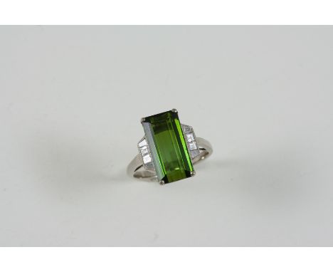 A TOURMALINE AND DIAMOND RING the rectangular-shaped green tourmaline is set with two square-shaped and two baguette-cut diam