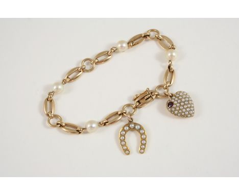 A 9CT. GOLD AND CULTURED PEARL FANCY LINK BRACELET suspending a 15ct. gold heart-shaped locket set with half pearls and a rub