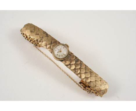 A LADY'S 14CT. GOLD WRISTWATCH BY ROLEX the signed circular dial with dagger and dot numerals, on an integrated fish scale de