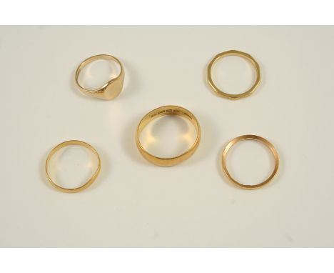 A WIDE 22CT. GOLD WEDDING BAND 8.0 grams, together with two other 22ct. gold wedding bands, 4.4 grams, an 18ct. gold ring, 2.