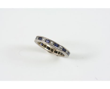 A SAPPHIRE AND DIAMOND FULL CIRCLE ETERNITY RING set with alternate circular-cut diamonds and rectangular-shaped sapphires. S