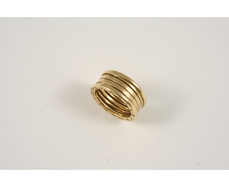 AN 18CT. GOLD RING BY BVLGARI formed as five concertinaed circles, signed Bvlgari twice to each side. Size R 1/2.