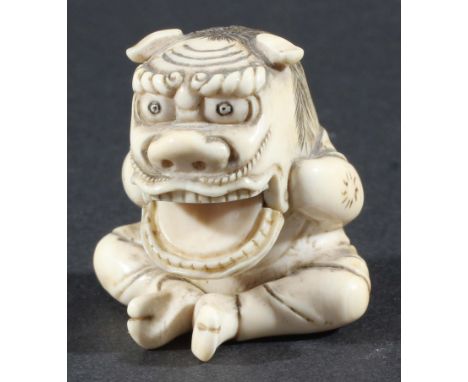 JAPANESE IVORY NETSUKE, modelled as a boy wearing an oni mask with hinged lower jaw revealing his face, height 4cm