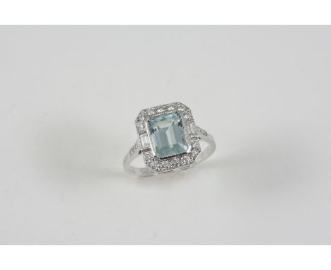 AN AQUAMARINE AND DIAMOND CLUSTER RING the rectangular-shaped aquamarine is set within a surround of two baguette-cut and fou