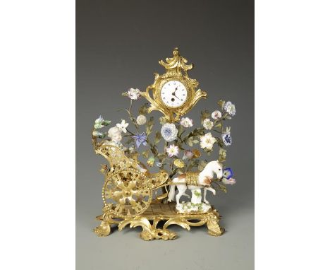 A FRENCH ORMOLU AND PORCELAIN MOUNTED MANTELPIECE ORNAMENT mounted with a pocket watch movement with white enamel dial formin