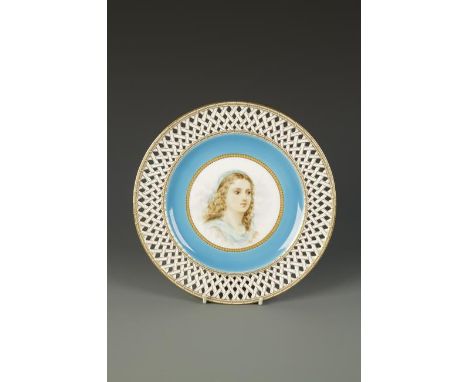 A MINTON PORCELAIN PLATE with a central gilt cartouche painted with a young female within blue and white lattice-work borders