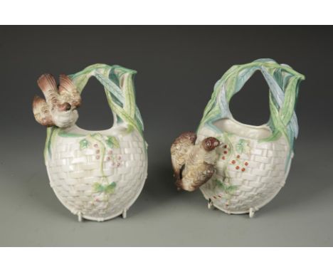 A PAIR OF CERAMIC WALL POCKET VASES of basket form with attached birds, 19th century, 9" (2)