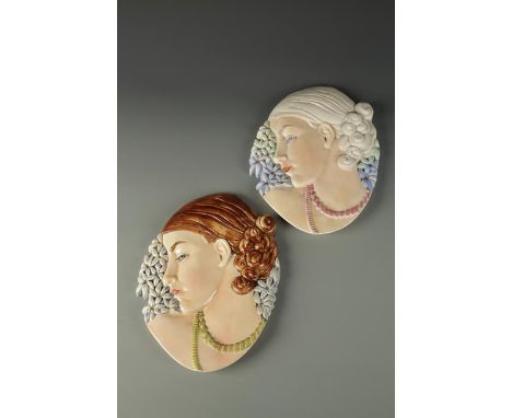 AN ART DECO BESWICK POTTERY WALL PLAQUE in the form of a ladies head in profile, surrounded by flowers and one other similar 