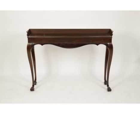 A GEORGE II MAHOGANY NARROW CONSOLE TABLE, the rectangular top with three-quarter tapering gallery above a shaped wavy edged 