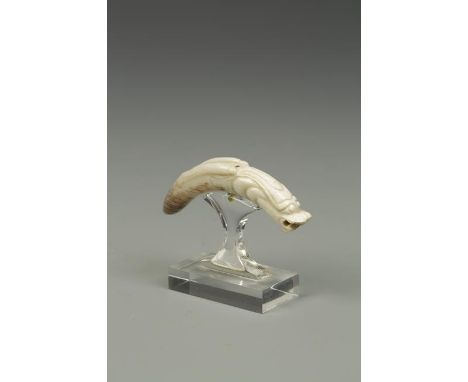 A CHINESE JADE PENDANT SECTION, or curved dragon form, Han or later, 2" long