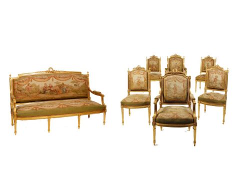 A LOUIS XVI STYLE GILTWOOD SALON SUITE comprising a three seater settee, a pair of fauteuils, and four chairs, all with backs