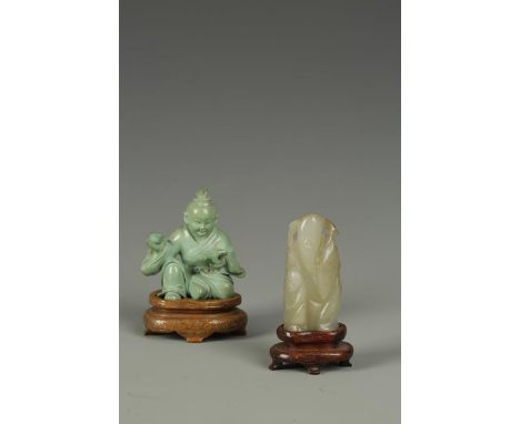 A CHINESE TURQUOISE SEATED FIGURE, probably the young Confucius, late Qing-Republic, 2" high; together with a jade carving of