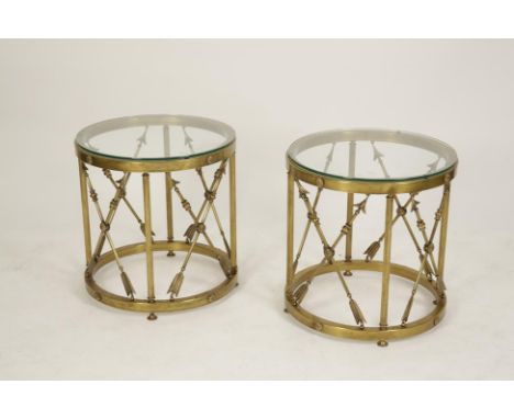 A PAIR OF EMPIRE STYLE PLATE GLASS AND GILT METAL OCCASIONAL TABLES with circular tops, on crossed arrow decorated bases, 20t
