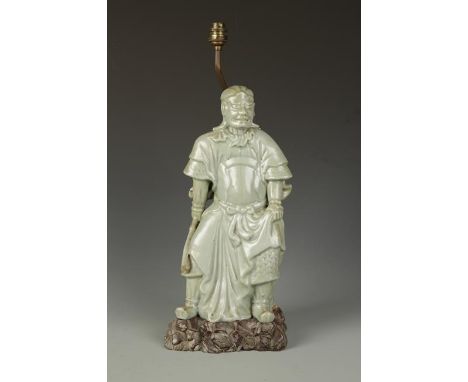 A LARGE JAPANESE CELADON WARRIOR FIGURE, Meiji, 15.5" high; on a hardwood stand converted for use as a lamp
