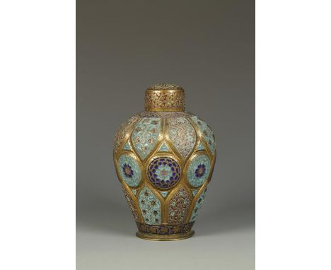 AN INDIAN GILT-COPPER AND ENAMEL CANISTER of shaped foliate form, each lobe decorated with flowerheads or flower sprays, 19th