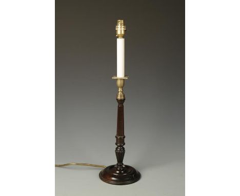 A SINGLE TURNED MAHOGANY CANDLESTICK with brass sconce and circular base, fitted as a table lamp, 21.5" high