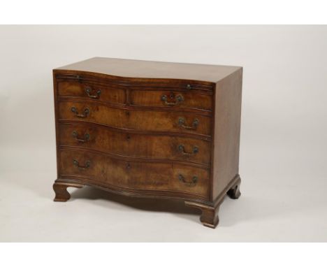 A GEORGE III MAHOGANY SERPENTINE FRONTED BACHELORS CHEST, the shaped caddy moulded top with chequered stringing above a brush