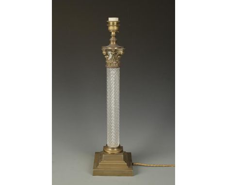 A MOULDED GLASS AND GILT METAL COLUMN FORM TABLE LAMP with square stepped base, 23" high