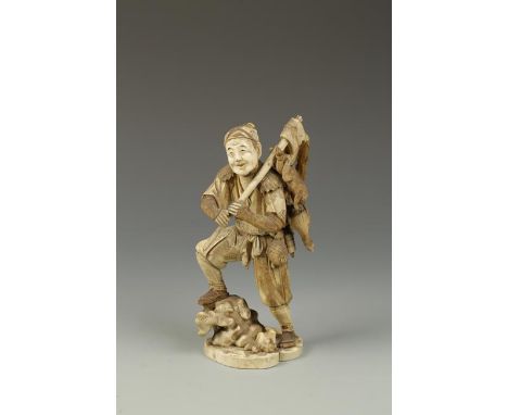 A JAPANESE IVORY OKIMONO of a hunter, the figure with one leg raised on rocks, carrying an axe and game over his shoulder, Me