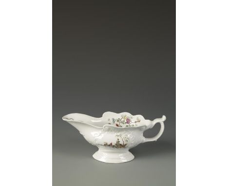 A WORCESTER SAUCEBOAT moulded with scrolled cartouches printed in black and painted with figures in Chinese river landscapes,
