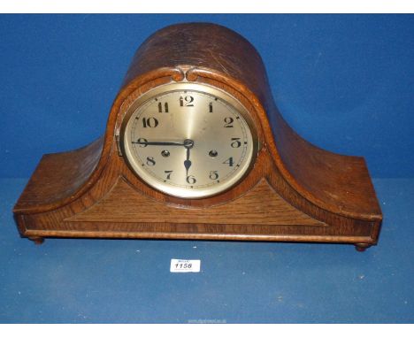 A two train movement Oak Napoleon mantle Clock with Arabic numerals. 18 1/2" wide x 10 1/2" high.