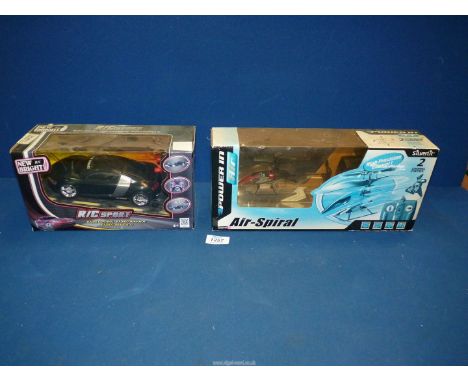 A remote control sports car and a remote control helicopter, both boxed.