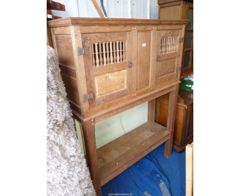 A primitive unpolished Oak Hutch Cupboard, the pair of opposing doors each having ten nicely turned spindles to the vends and