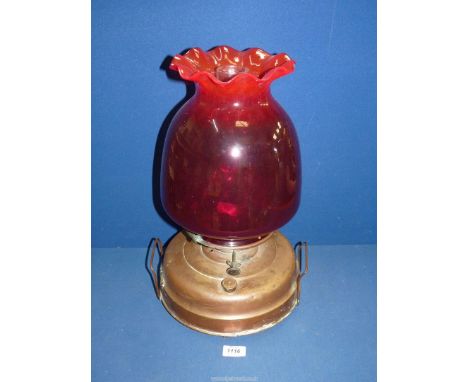 A Church heater/oil lamp with copper base, ruby red shade with fluted rim and chimney, 17 3/4" tall.