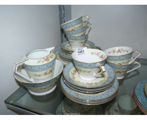 A Noritake tea service (no teapot) decorated with cream bands having floral pattern within a pale blue border of Acanthus sty