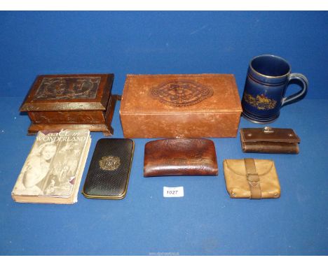 A tray containing an embossed leather box containing four wallets and a card case, a carved wooden box with the initials "CM"