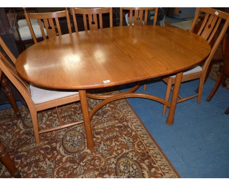 A very stylish "Ercol" Elm oval extending Dining Table standing on unusual club shaped legs united by bowed stretchers and wi