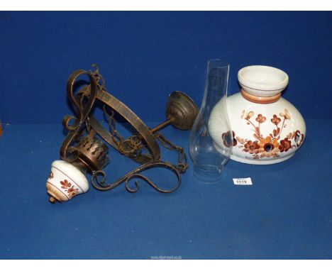 A ceiling hanging oil lamp, converted to electric with ceramic shade and glass chimney.