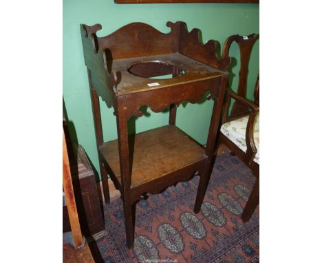 A Georgian Oak campaign Washstand having a bowl recess, the square legs being united by a lower shelf and the piece being det