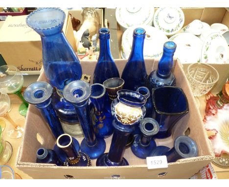 A quantity of blue glass to include; four candlesticks, four vases having floral decoration, an oil lamp, a vase and five bot