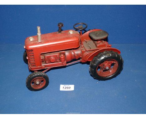 A red metal model tractor by Lesser and Pavey Ltd., 10 1/2" x 6"