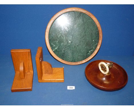 A green circular marble stand set in cedar (13" diameter), a patent Oak ships wheel nut cracker (9 1/2" diameter) and a pair 