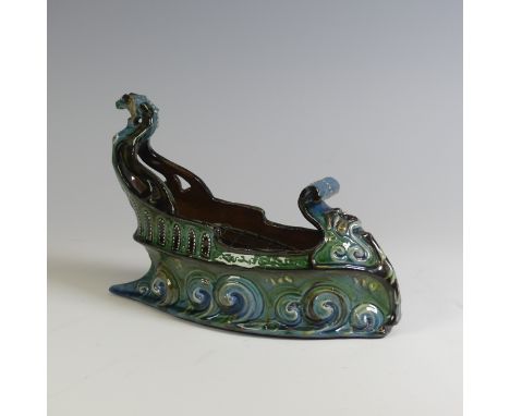 A C. H. Brannam pottery boat shaped flower Trough, with mystical beast figurehead on scrolling waves, with tones of green, tu