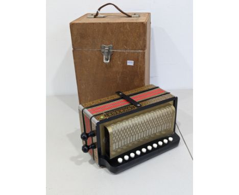 A vintage German Hohner ten-button, one row, two voice, Cajun Accordion/Melodeon, the black and gold case with floral detail,