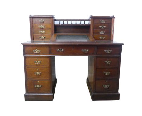 A Victorian mahogany Dickens Desk, the top with shelf and gallery flanked by wellington style drawers, above sloped hinged le